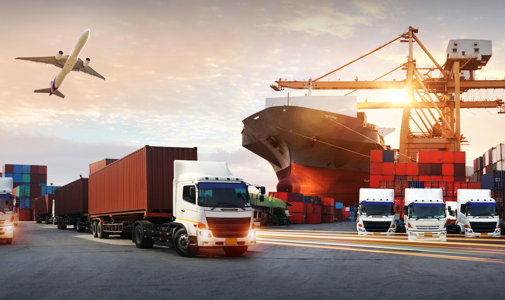 Trucks, containers, cargo ship, and airplane in an integrated logistics hub
