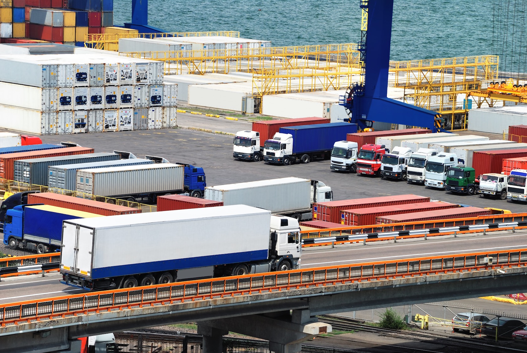 Freight trucks and containers at a warehouse and port facility